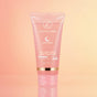 Pink skincare tube on a gradient pink background